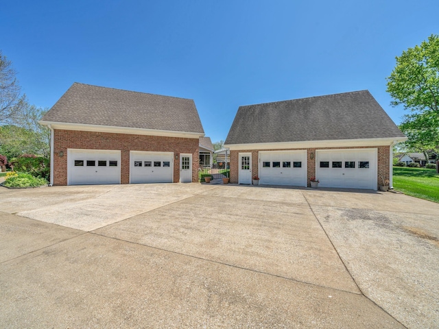 409 Savannah Trace Dr, Clarksville, TN 37043 - exterior space with a shingled roof, an outbuilding, brick siding, and a detached garage