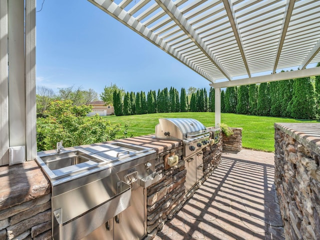 409 Savannah Trace Dr, Clarksville, TN 37043 - view of patio featuring a pergola, a view of trees, a grill, and exterior kitchen