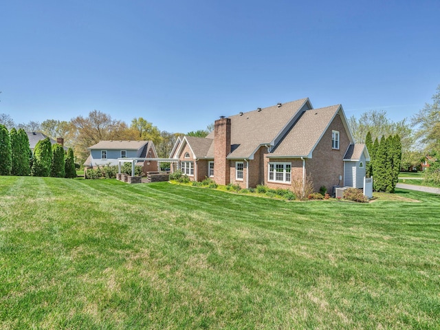 409 Savannah Trace Dr, Clarksville, TN 37043 - back of house featuring a chimney, brick siding, and a yard