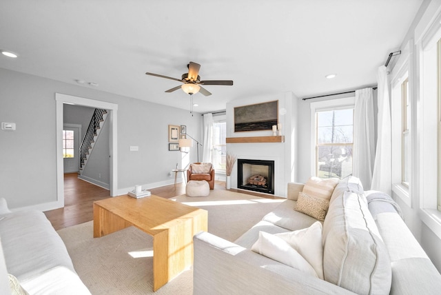 living room with ceiling fan and light wood-type flooring