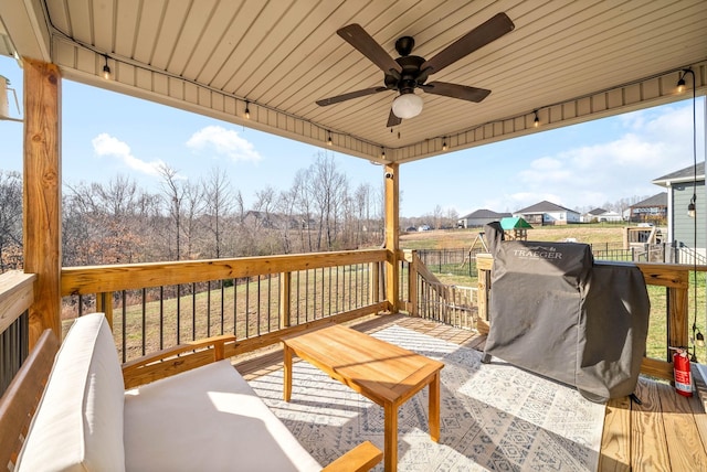 deck with outdoor lounge area and ceiling fan