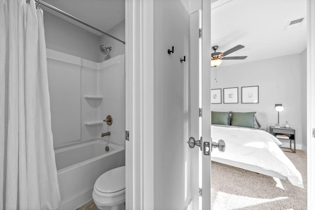 bathroom featuring ceiling fan, shower / tub combo with curtain, and toilet