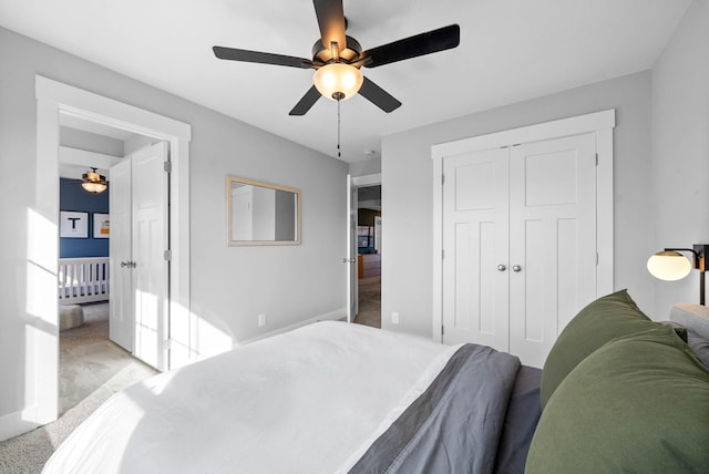 bedroom featuring ceiling fan, light colored carpet, and a closet