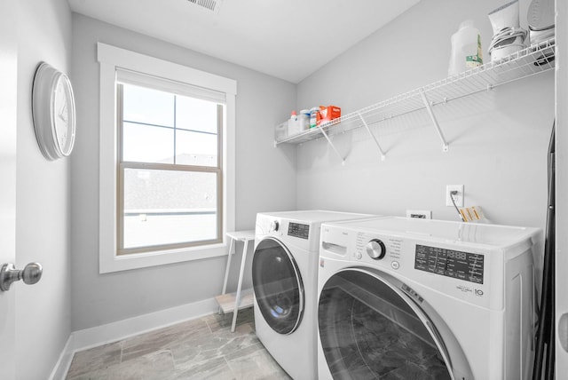 clothes washing area featuring washer and clothes dryer