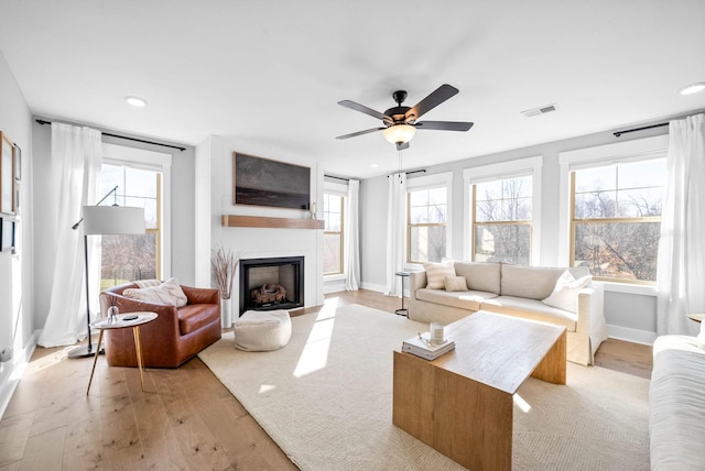 living room featuring light hardwood / wood-style floors and ceiling fan