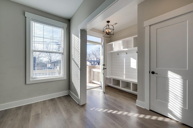 mudroom featuring light hardwood / wood-style floors and an inviting chandelier