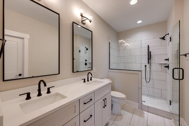 bathroom featuring toilet, vanity, and walk in shower