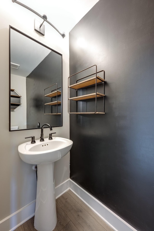 bathroom with wood-type flooring