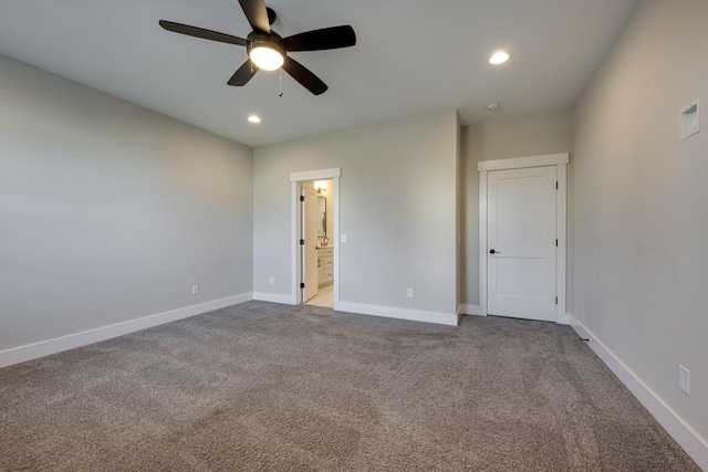 unfurnished bedroom featuring connected bathroom, ceiling fan, and light carpet