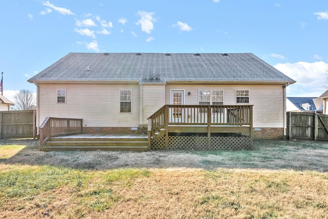 back of house featuring a deck and a lawn