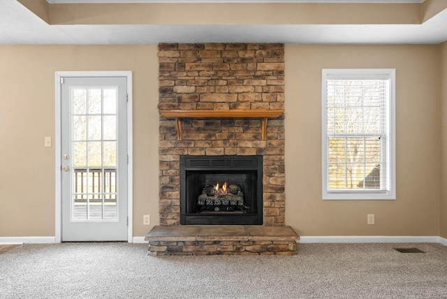 unfurnished living room featuring carpet flooring and a fireplace