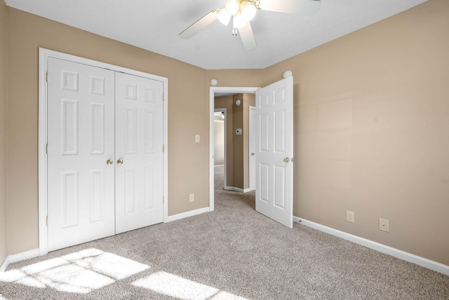 unfurnished bedroom with ceiling fan, a closet, and light carpet