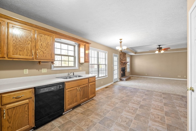 kitchen with ceiling fan with notable chandelier, sink, pendant lighting, a fireplace, and black dishwasher