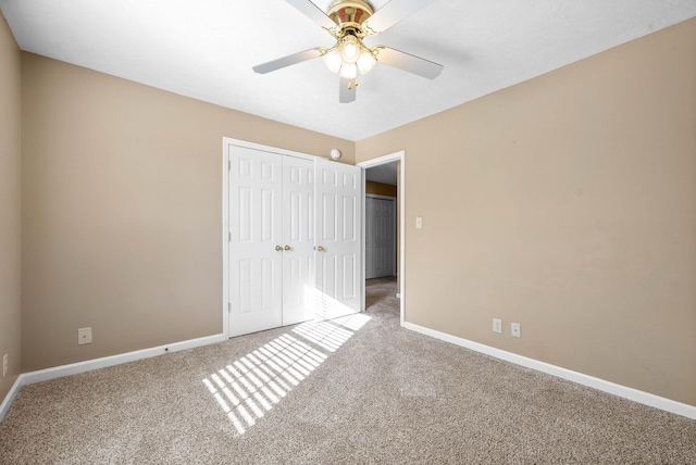 unfurnished bedroom featuring carpet flooring, a closet, and ceiling fan