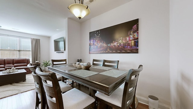 dining space with hardwood / wood-style floors