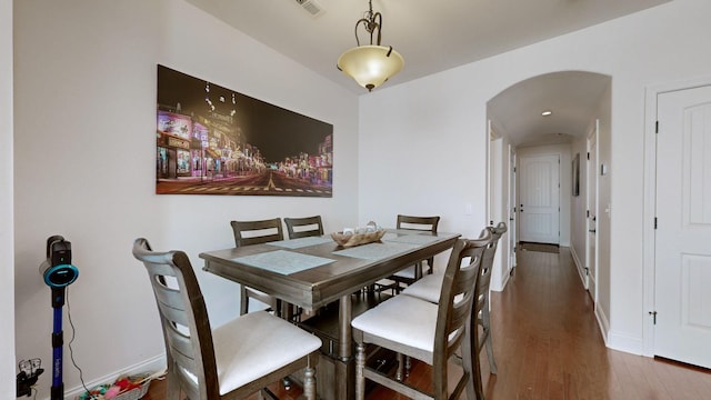 dining space featuring dark wood-type flooring