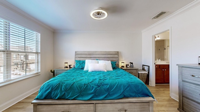 bedroom featuring ensuite bath, crown molding, and light hardwood / wood-style flooring