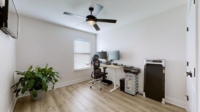 home office featuring ceiling fan and light hardwood / wood-style flooring