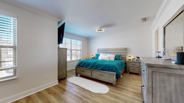 bedroom with light hardwood / wood-style floors and ornamental molding