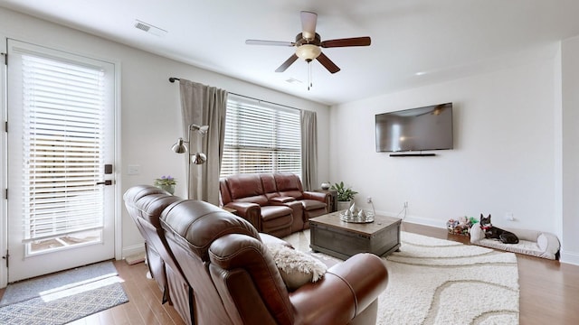 living room featuring ceiling fan and light wood-type flooring