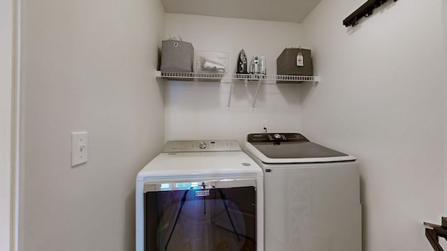 clothes washing area featuring washing machine and clothes dryer