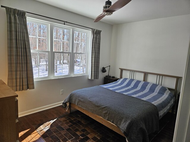 bedroom with ceiling fan and dark wood-type flooring