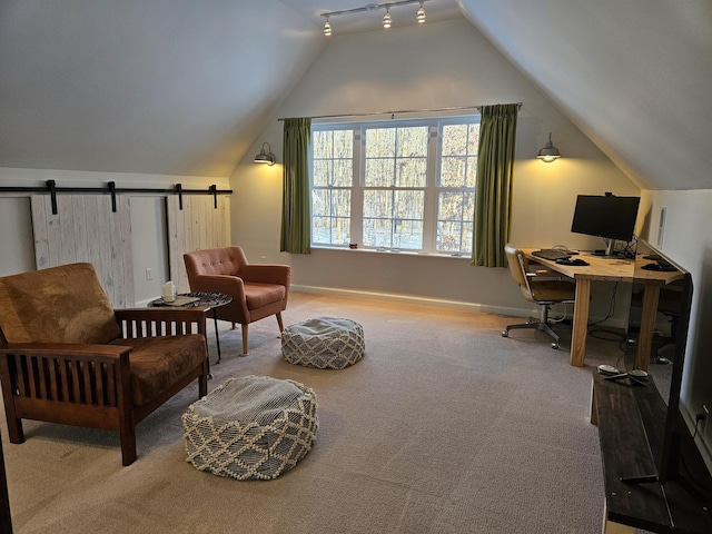 carpeted home office featuring vaulted ceiling