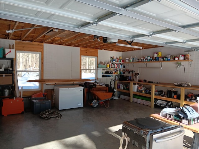 garage featuring refrigerator and a garage door opener