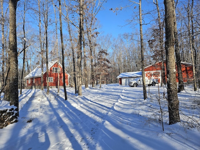 snowy yard with an outbuilding