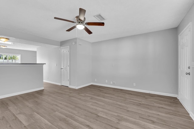 empty room featuring light wood-type flooring and ceiling fan