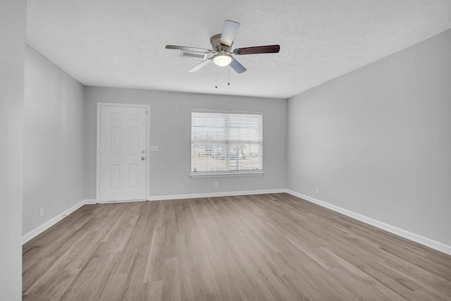 spare room with ceiling fan, a textured ceiling, and light hardwood / wood-style flooring