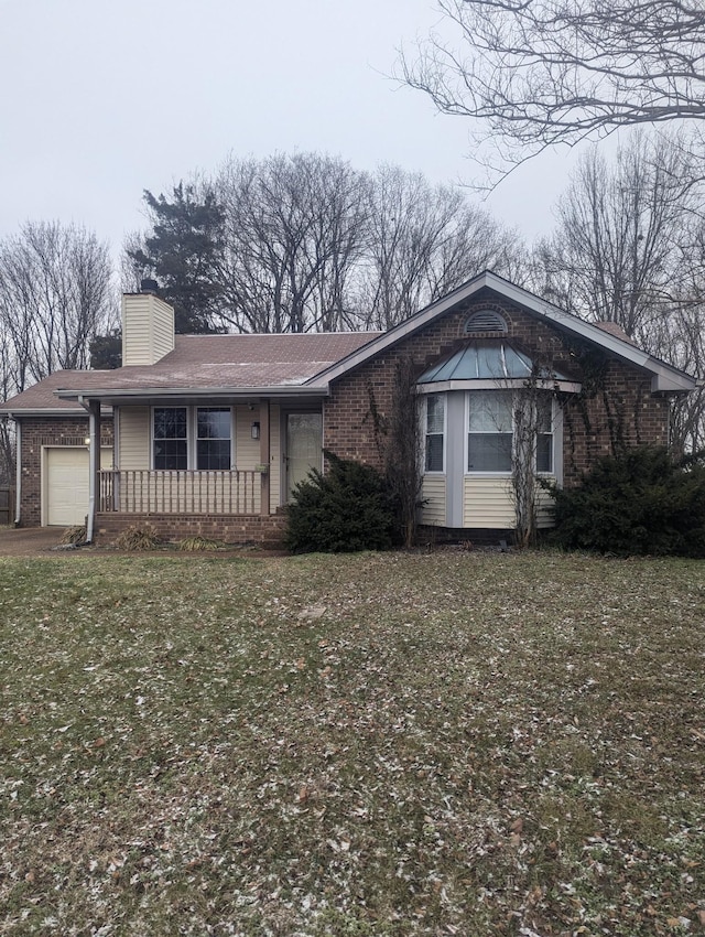 ranch-style home with a front lawn and a garage