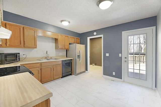 kitchen with sink, ventilation hood, black appliances, and a textured ceiling