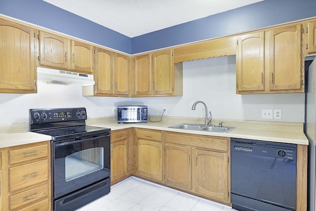 kitchen with sink, black appliances, and a textured ceiling