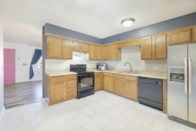 kitchen with sink, a textured ceiling, and black appliances