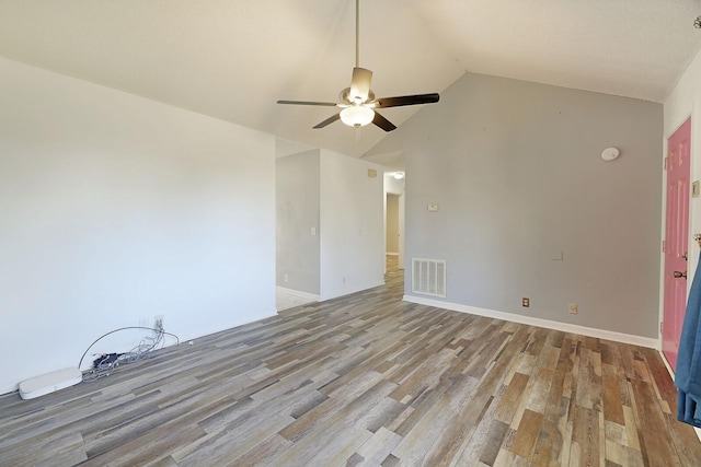 empty room featuring vaulted ceiling, ceiling fan, and light wood-type flooring