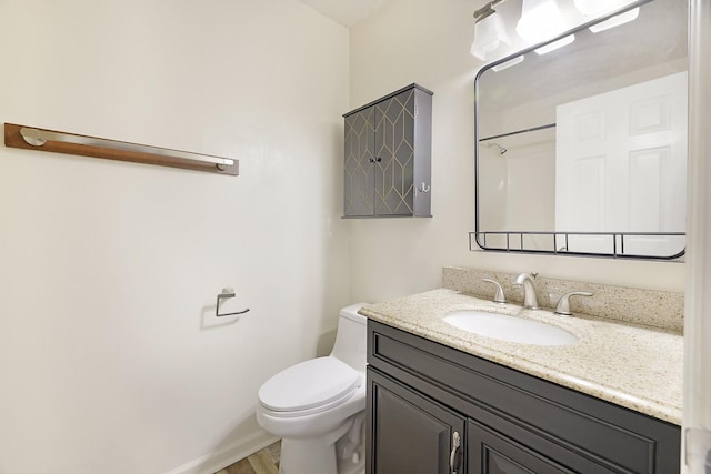 bathroom with vanity, hardwood / wood-style flooring, a shower, and toilet