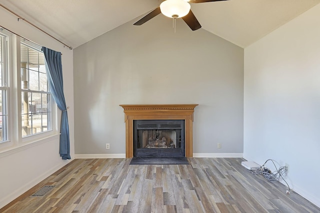 unfurnished living room with vaulted ceiling, ceiling fan, and light wood-type flooring