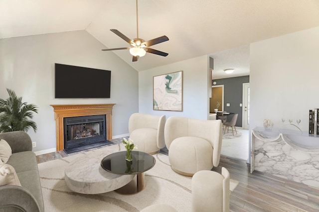 living room with ceiling fan, lofted ceiling, and wood-type flooring