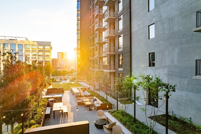 surrounding community featuring an outdoor living space and a patio area