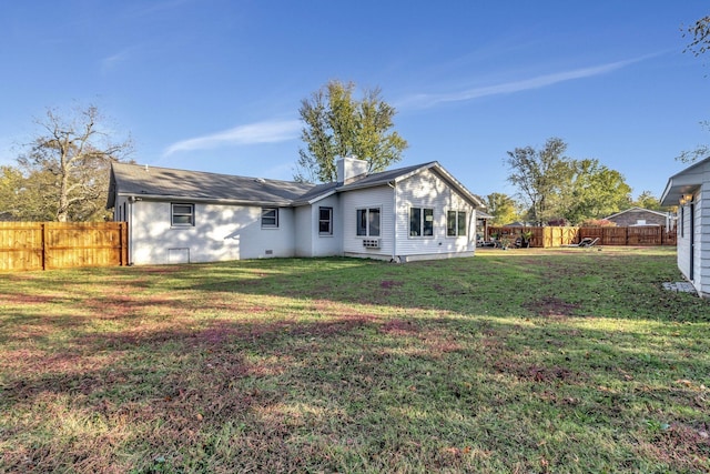 rear view of property featuring a yard