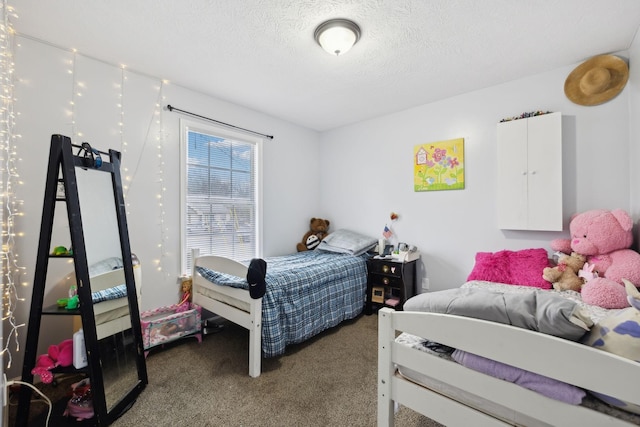 bedroom featuring dark carpet and a textured ceiling