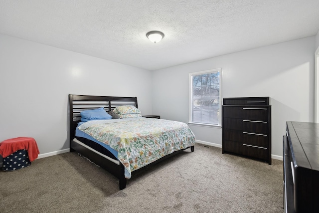 carpeted bedroom featuring a textured ceiling