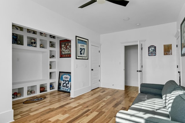 living room featuring built in features and hardwood / wood-style flooring