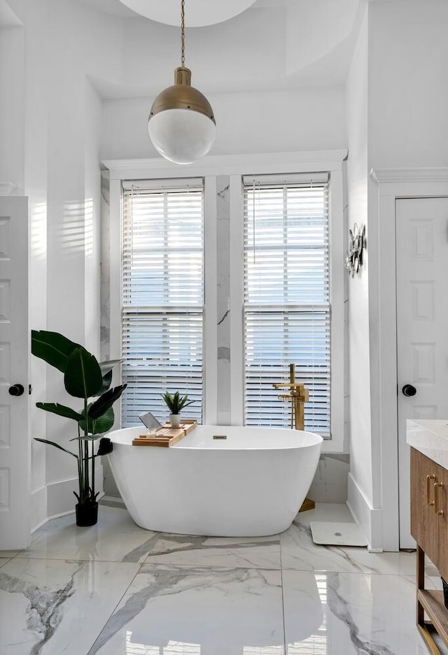 bathroom featuring vanity and a tub to relax in