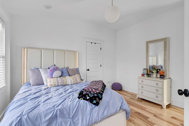 bedroom with light hardwood / wood-style flooring and multiple windows