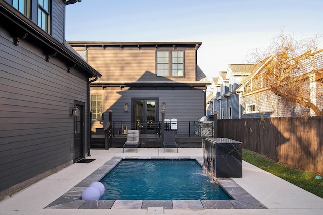 view of pool with pool water feature and a patio