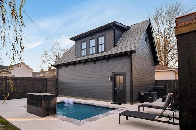 back of house featuring a fenced in pool and a patio