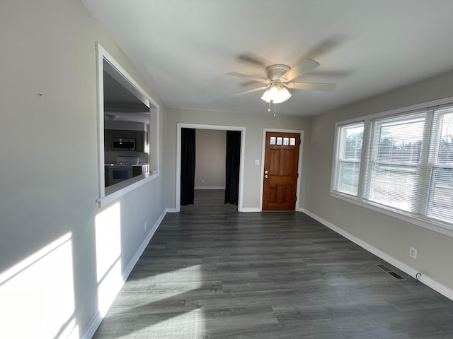 foyer with ceiling fan and dark wood-type flooring