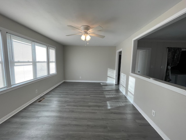 unfurnished room with ceiling fan, dark hardwood / wood-style flooring, and ornamental molding